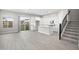 Open living room with kitchen island and modern staircase at 4923 E Village Dr, Scottsdale, AZ 85254