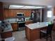 Galley kitchen with stainless steel appliances and island at 6202 W Highland Ave, Phoenix, AZ 85033