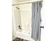 Clean bathroom with tub shower, striped curtain, and wood-look floors at 701 S Dobson Rd # 158, Mesa, AZ 85202