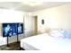 Primary bedroom with large bed and mounted TV at 701 S Dobson Rd # 158, Mesa, AZ 85202