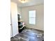 Spare bedroom with wood-look flooring and large window at 701 S Dobson Rd # 158, Mesa, AZ 85202