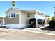 Single-wide manufactured home with carport and partial view of the neighborhood at 701 S Dobson Rd # 158, Mesa, AZ 85202