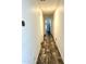 Long hallway with wood-look flooring leading to bedrooms and bathroom at 701 S Dobson Rd # 158, Mesa, AZ 85202