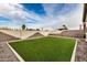 Artificial turf backyard with gravel border and brick pavers at 16854 W Alice Ave, Waddell, AZ 85355