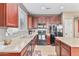 Modern kitchen featuring dark wood cabinets and black appliances at 17297 N Cosa St, Maricopa, AZ 85138