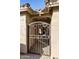 Private courtyard with wrought iron gate and seating area at 24414 S Lakeway Sw Cir, Sun Lakes, AZ 85248