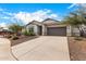 Newly built home with a two-car garage, and desert landscaping at 24686 N 184Th Ln, Wittmann, AZ 85361