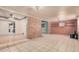 Spacious basement recreation room with tiled floors and brick accent wall at 24906 W Boone Dr, Casa Grande, AZ 85193