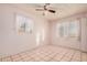 Bright bedroom featuring tiled floors and dual windows at 24906 W Boone Dr, Casa Grande, AZ 85193