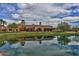 Community clubhouse with pond reflection at 3440 N Boulder Ct, Buckeye, AZ 85396