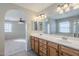 Double vanity bathroom with a view into the bedroom at 3683 E Leslie Dr, Gilbert, AZ 85296