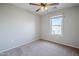 Simple bedroom with ceiling fan and window at 3683 E Leslie Dr, Gilbert, AZ 85296