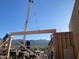 Crane lifting a large wooden beam into place during construction at 3703 S Avenida De Angeles --, Gold Canyon, AZ 85118