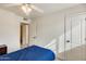 Bedroom with ceiling fan, window and door at 6138 W Park View Ln, Glendale, AZ 85310