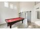 Game room with pool table and sliding barn doors at 6138 W Park View Ln, Glendale, AZ 85310