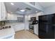 Updated kitchen with white cabinets and stainless steel appliances at 6819 E Grandview Dr, Scottsdale, AZ 85254