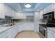 Modern kitchen with white cabinets and tile backsplash at 6819 E Grandview Dr, Scottsdale, AZ 85254