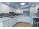 Bright kitchen with white cabinets, mosaic backsplash, and modern appliances at 6819 E Grandview Dr, Scottsdale, AZ 85254