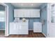 Laundry room with white cabinets, washer, dryer, and utility sink at 6819 E Grandview Dr, Scottsdale, AZ 85254