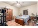 Bedroom with wood flooring, a ceiling fan, and a walk-in closet at 7214 N 183Rd Ave, Waddell, AZ 85355