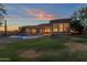 Large backyard with a pool and grassy area, perfect for outdoor entertaining at 9325 E Paraiso Dr, Scottsdale, AZ 85255