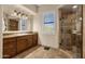 Bathroom with walk-in shower and wood cabinets at 9325 E Paraiso Dr, Scottsdale, AZ 85255