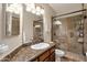 Elegant bathroom with granite vanity and large glass shower at 9325 E Paraiso Dr, Scottsdale, AZ 85255