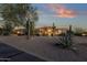 Desert home exterior at dusk showcasing the front yard and architectural details at 9325 E Paraiso Dr, Scottsdale, AZ 85255