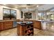 Open kitchen with island, granite countertops, and view to living room at 9325 E Paraiso Dr, Scottsdale, AZ 85255