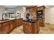 Island kitchen with wood cabinets and granite countertops at 9325 E Paraiso Dr, Scottsdale, AZ 85255