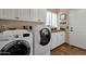 Bright laundry room with washer, dryer, and ample storage at 9325 E Paraiso Dr, Scottsdale, AZ 85255