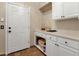 Well-appointed laundry room with cabinets and counter space at 9325 E Paraiso Dr, Scottsdale, AZ 85255