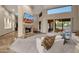 Elegant living room with fireplace and access to backyard at 9325 E Paraiso Dr, Scottsdale, AZ 85255