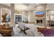 Bright living room with a fireplace and large windows at 9325 E Paraiso Dr, Scottsdale, AZ 85255