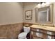 Elegant powder room with decorative mirror and tile at 9325 E Paraiso Dr, Scottsdale, AZ 85255