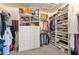 Bright walk-in closet with custom shelving and drawers at 9325 E Paraiso Dr, Scottsdale, AZ 85255