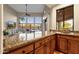 Home bar with granite countertop and view to living room at 9325 E Paraiso Dr, Scottsdale, AZ 85255
