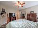 Bright bedroom with wood furniture and a ceiling fan at 16204 W Hilton Ave, Goodyear, AZ 85338