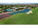 Aerial view of community with pool, lake, and golf course at 7132 W Trenton Way, Florence, AZ 85132