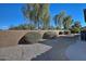 Landscaped backyard with gravel, shrubs, and a block wall at 7132 W Trenton Way, Florence, AZ 85132