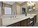 Double sink bathroom vanity with large mirror and block window at 7132 W Trenton Way, Florence, AZ 85132