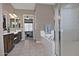 Spa-like bathroom with soaking tub, walk-in shower, and tiled floors at 7132 W Trenton Way, Florence, AZ 85132