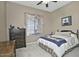 Comfortable bedroom with wood furniture and a large window at 7132 W Trenton Way, Florence, AZ 85132