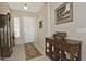 Bright and airy entryway with decorative flooring and a wooden console table at 7132 W Trenton Way, Florence, AZ 85132