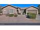 Single-story home with landscaped front yard and two-car garage at 7132 W Trenton Way, Florence, AZ 85132