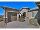 View of the garage and walkway leading to the home's entrance at 7132 W Trenton Way, Florence, AZ 85132