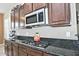Kitchen features gas cooktop, stainless steel microwave, and granite countertops at 7132 W Trenton Way, Florence, AZ 85132