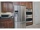 Stainless steel appliances and ample wood cabinets in this kitchen at 7132 W Trenton Way, Florence, AZ 85132