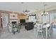 Open floor plan living room and dining area with a cozy fireplace at 7132 W Trenton Way, Florence, AZ 85132