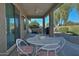 Relaxing covered patio with seating area and ceiling fan at 7132 W Trenton Way, Florence, AZ 85132